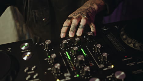 dj hands controlling equipment at club party making rhythmic performance closeup