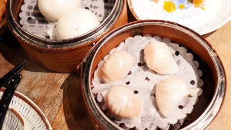 assorted dim sum dishes on a wooden table