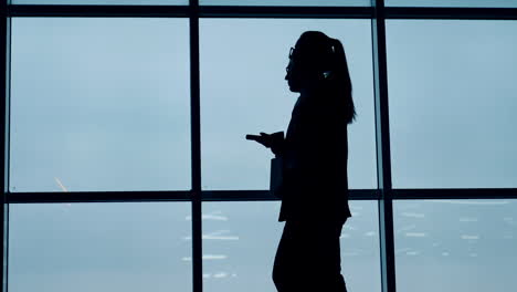 office people during a break near the window. silhouettes of colleagues having a talk. low angle view.