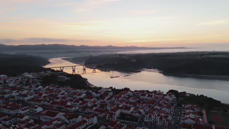 sunrise view of road bridge over river mira in the town of vila nova de milfontes, alentejo, portugal