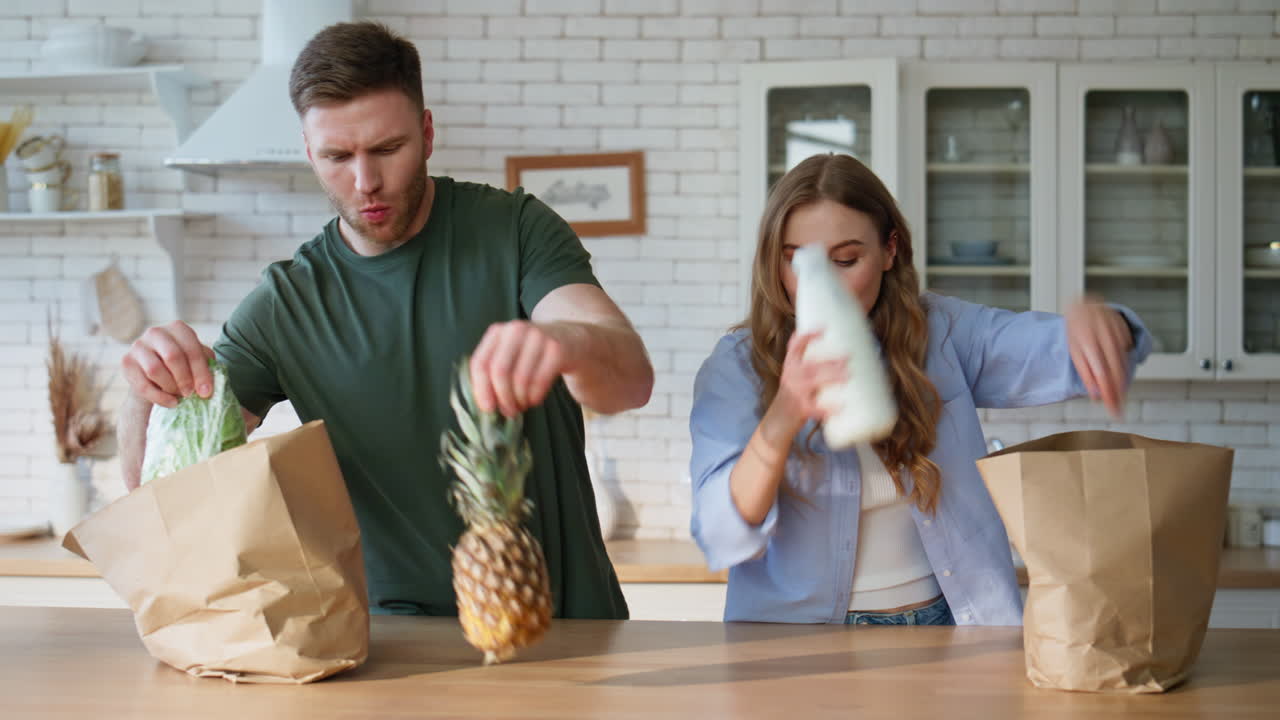 Spouses arrived grocery store putting shoppings table closeup. Family unpacking