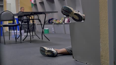 people resting in a locker room