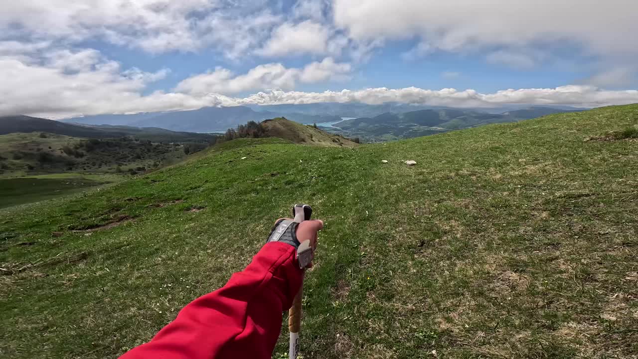 First-person view while hiking in the French Alps. Scenic mountain trail, lush greenery, and an immersive outdoor experience. Ideal for adventure, travel, or nature themes.