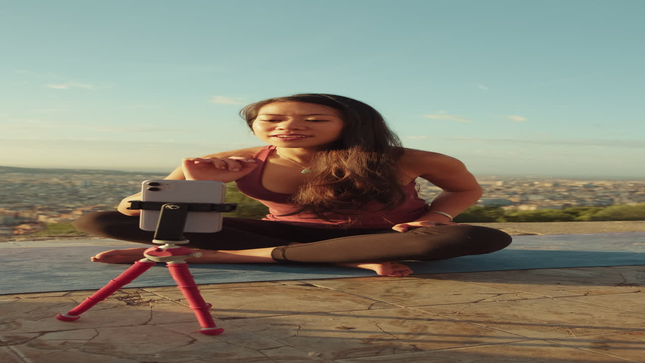 Woman Doing Yoga and Vlogging Outdoors