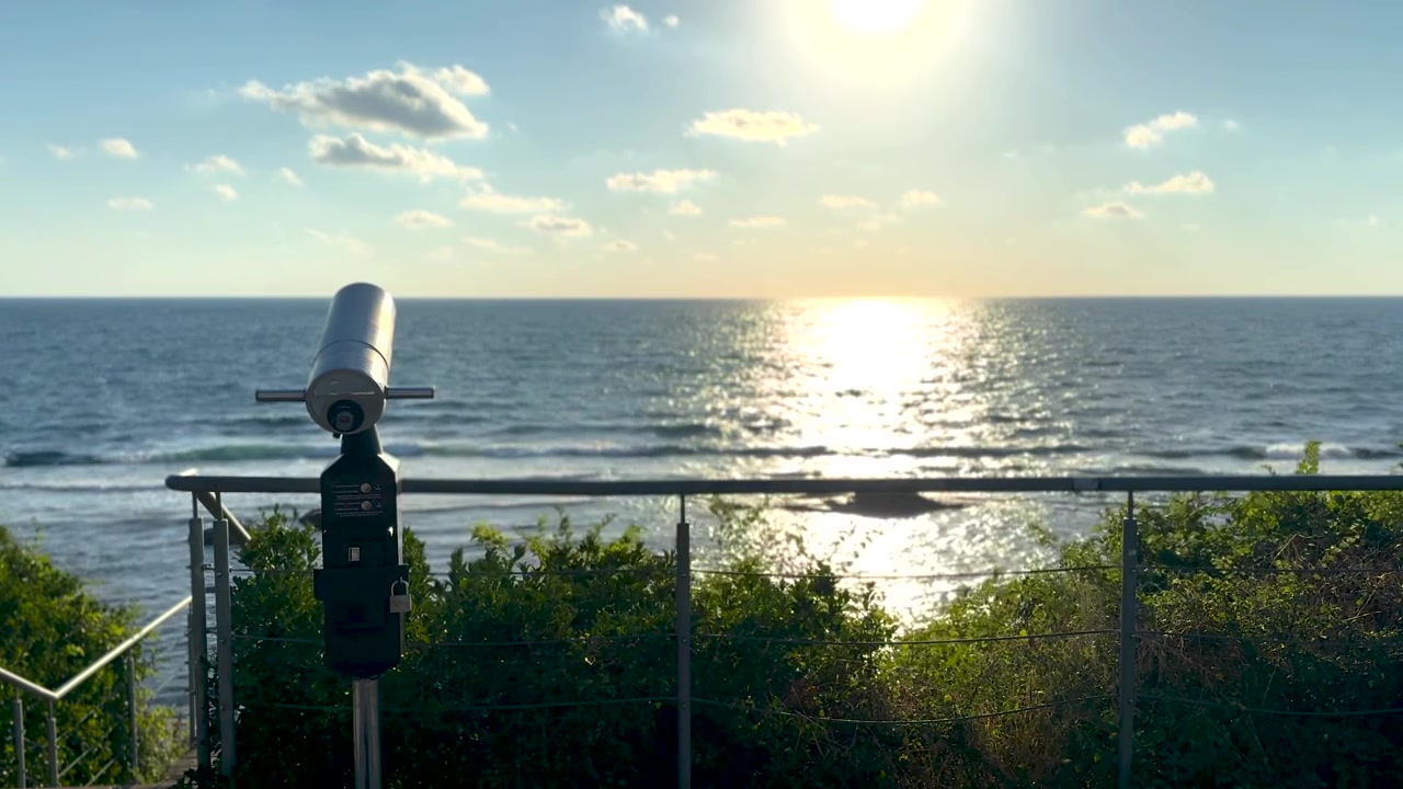Sightseeing binoculars overlooking the sea at sunrise, panoramic ocean horizon view from an empty coastal observation deck, peaceful golden morning landscape. Scene F.
