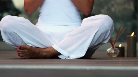 woman in white sitting in lotus pose