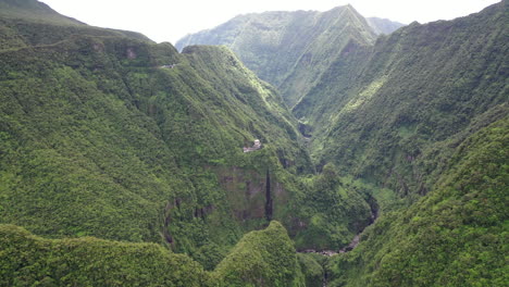 aerial view over mountains on reunion island with the takamaka waterfalls and marsouins river below