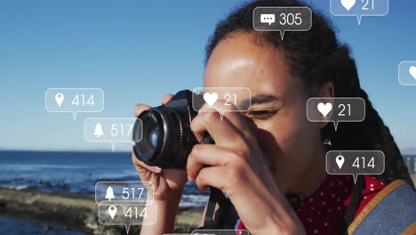 taking photo, person with social media notifications animation over coastal background