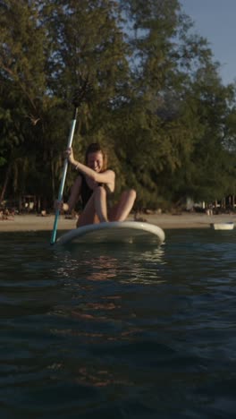 woman paddleboarding on the ocean
