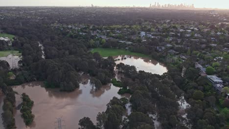 aerial view over the yarra flats park inundated with flood water on 14 october 2022, with the melbourne city skyline in the background