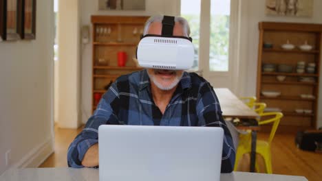 senior man using virtual reality headset in kitchen 4k