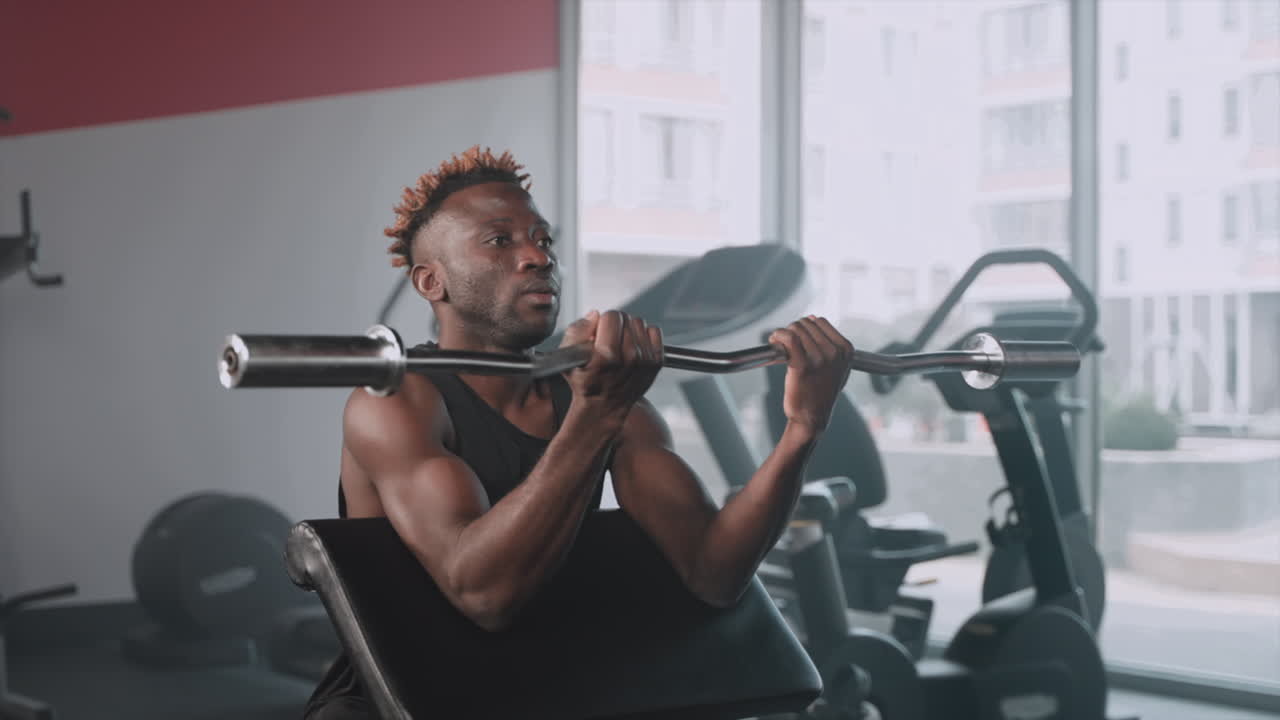 Man Working Out with Barbell in Gym