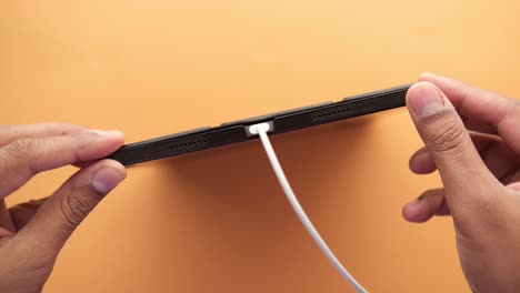 charging smart phone with a cable on  background