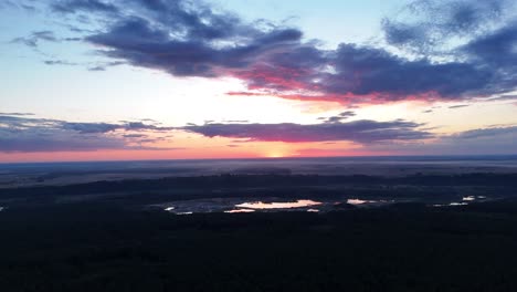 stunning aerial sunset over forest and lakes