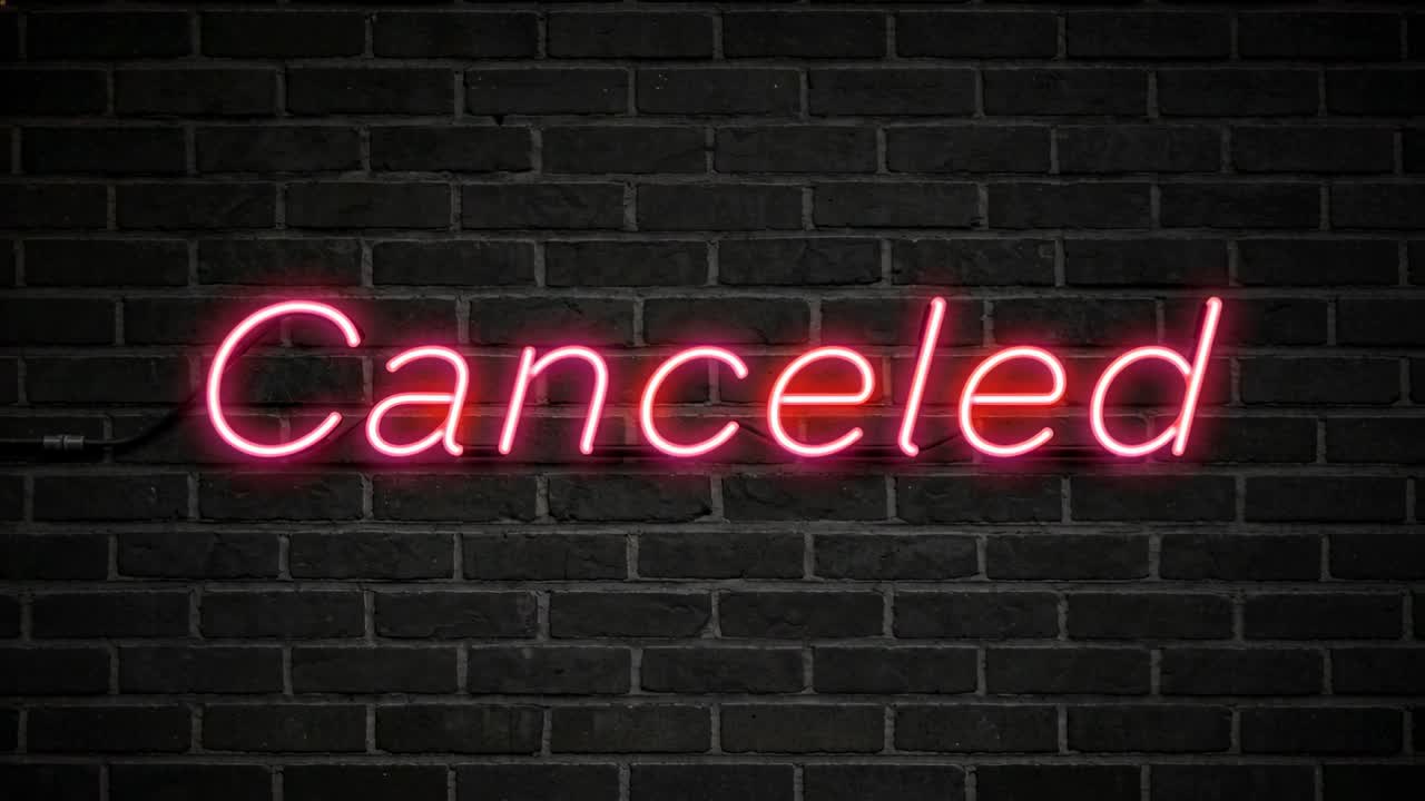 Pulsing pink neon Canceled sign powered by left cable, drawing notice on brick wall mounts