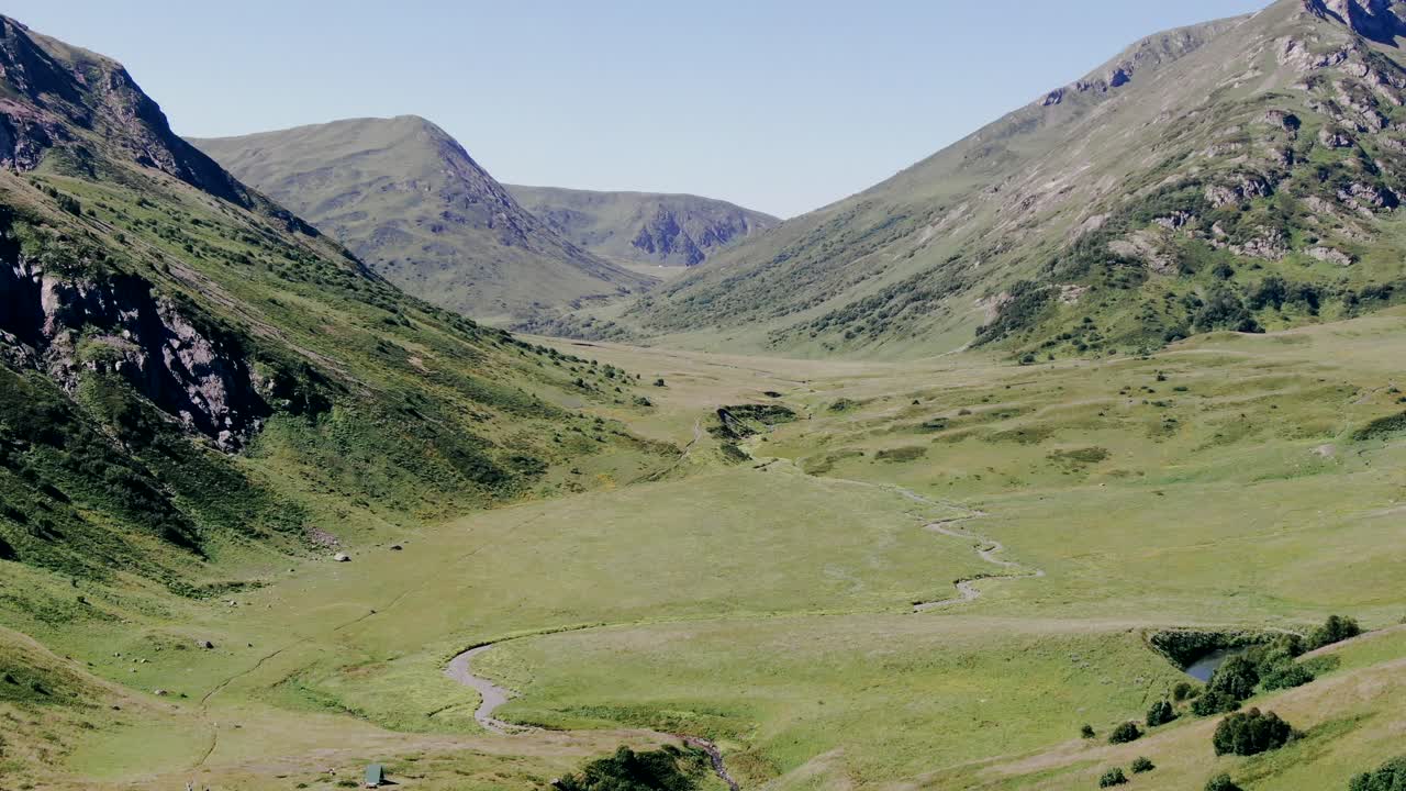 View from the high track in caucasus mountains glaciers, green grass, wild lakes