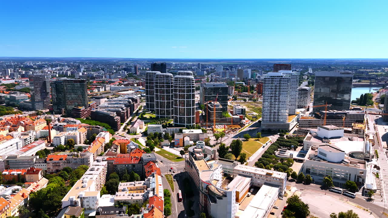 Bratislava, Slovakia - June 14, 2025: Bratislava's skyline is modern. View of Bratislava's cityscape with contemporary buildings, lush green spaces, and vibrant rooftops under a clear sky