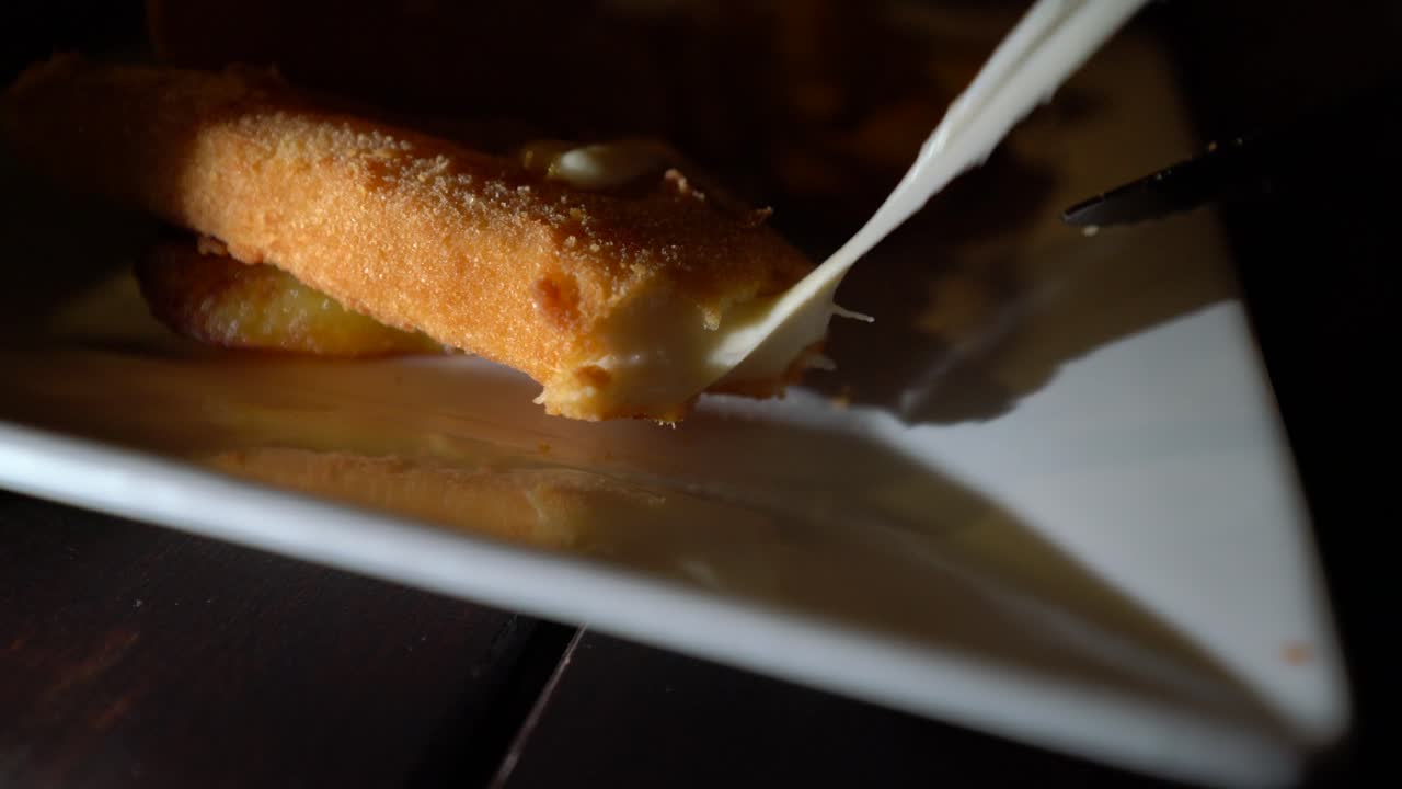 Vyprazany syr fried cheese Czech cuisine, cutting in slow motion stretchy cheese