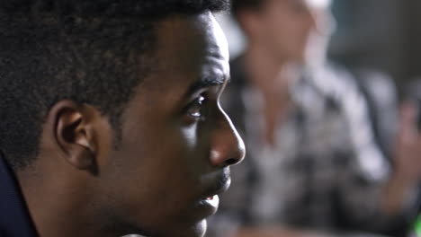 camera focuses on a young as he watches sports on television and despairs