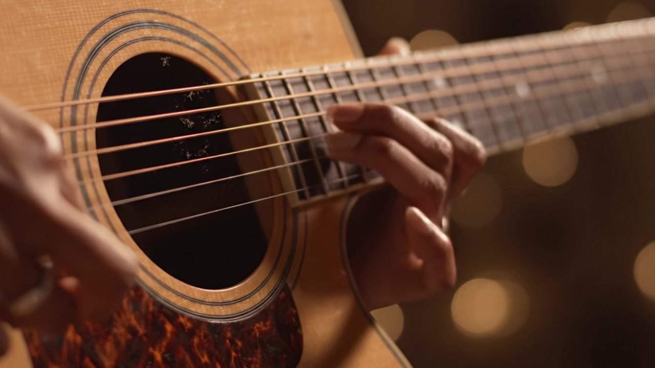 An Intimate Close-Up of Acoustic Guitar Playing, Showcasing Expert Fingerstyle Technique and the Rustic Beauty of the Instrument Amidst a Softly Lit Background