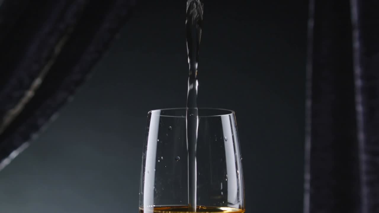 Reaching rim, narrow golden stream filling tall stem flute at studio, creating rising bubble column