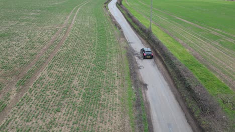 car slows down to navigate large potholes followed by lorry drone aerial english countryside