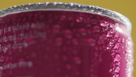 Close-Up-Of-Condensation-Droplets-On-Revolving-Takeaway-Can-Of-Cold-Beer-Or-Soft-Drink-Against-Yellow-Background-2