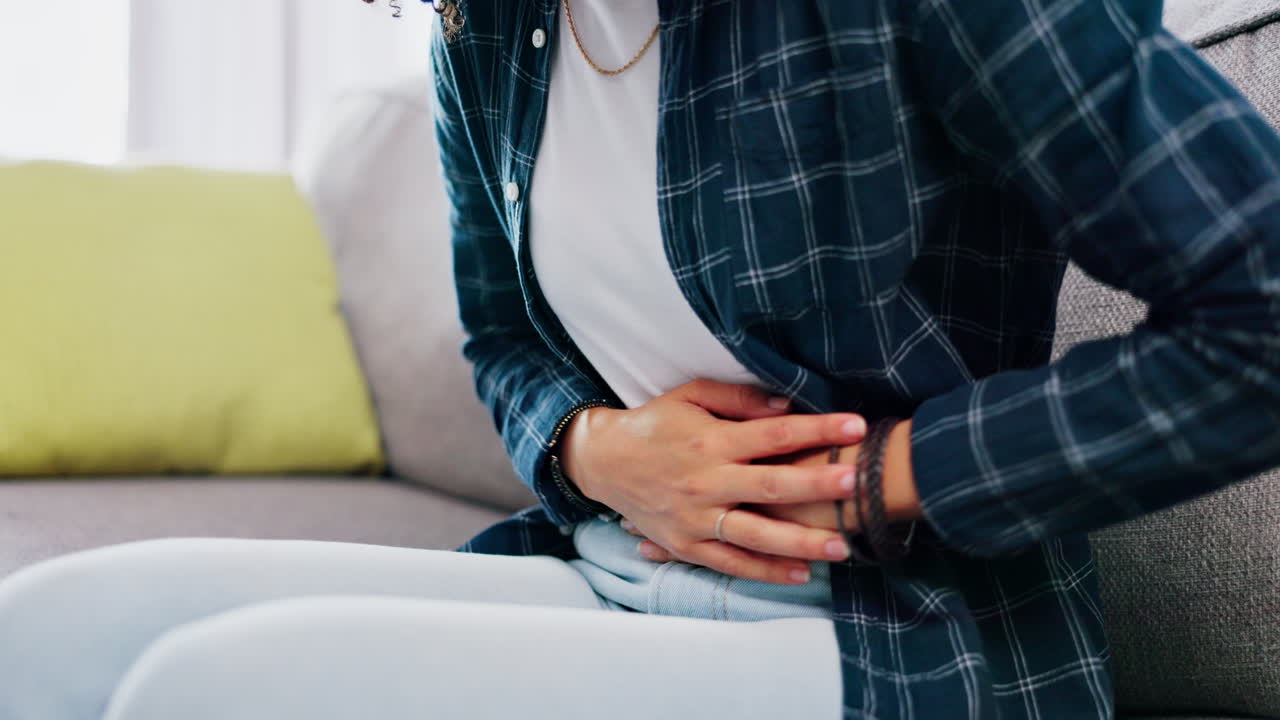 Sick woman, stomach pain and hands on abdomen