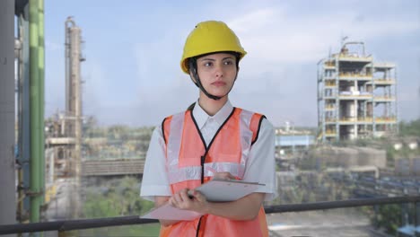 indian female architect taking notes in building