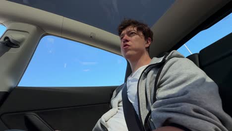 man sitting in a tesla