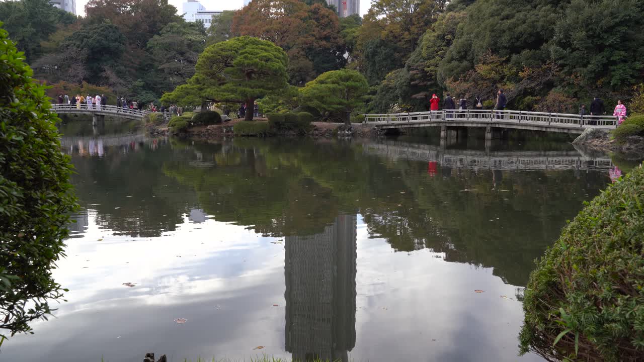 Beautifully Landscaped Garden Surrounding Pond In Shinjuku Gyoen, Tokyo Japan - wide shot