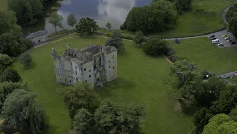 stunning castle ruins with a cooling refreshing lake behind with reflections