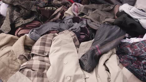 close up shot of vintage clothing piled up at a market