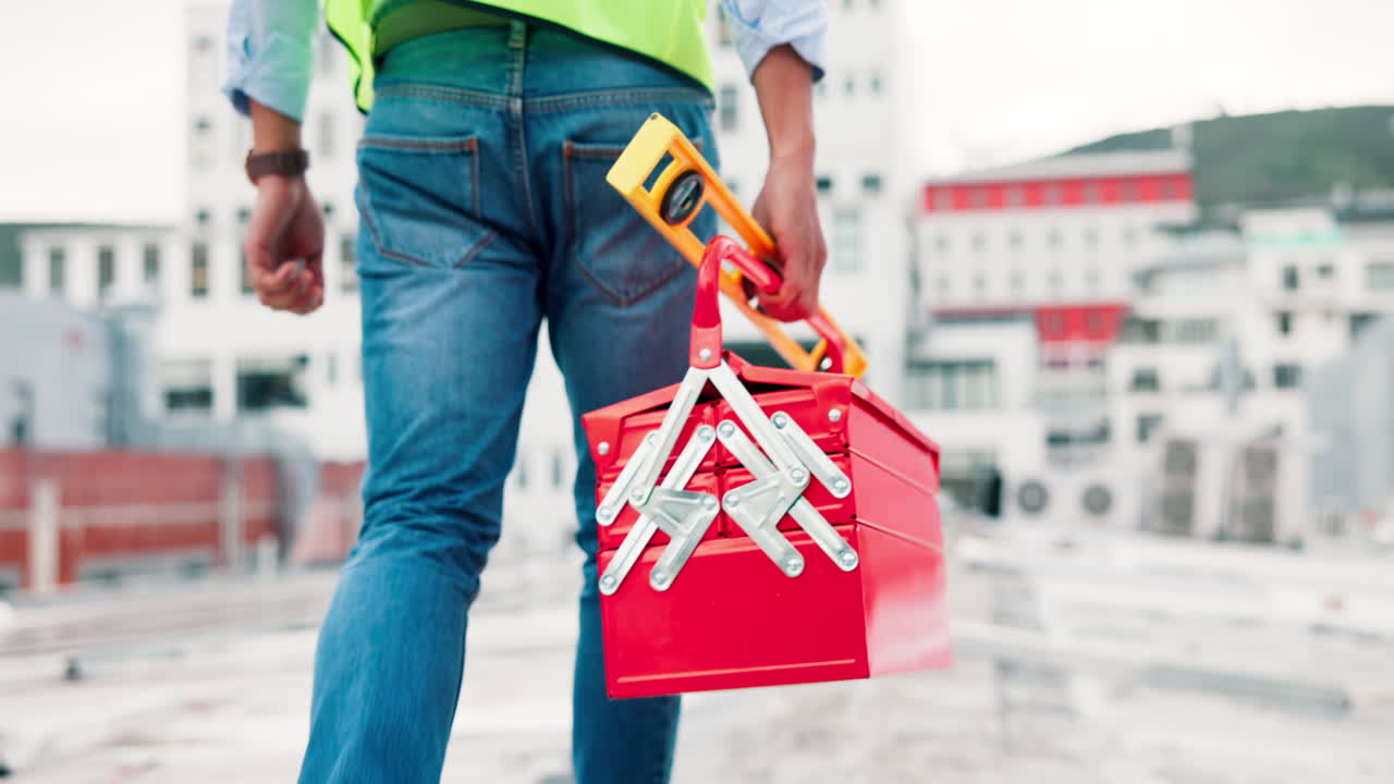 Construction Worker on Rooftop with Toolbox