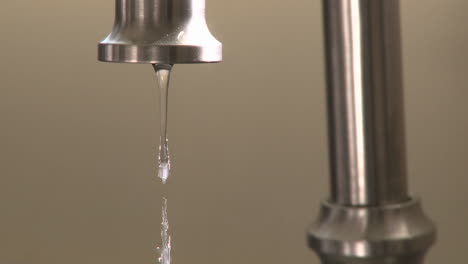 Close-up-of-water-dripping-fast-from-a-faucet-in-Oak-View-California-1