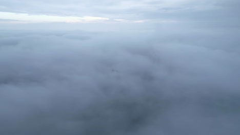 ruins on mountain peak above clouds on foggy day