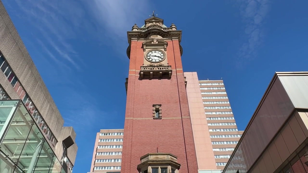 View of the Victoria Centre Clock Tower on Milton Street in Nottingham city centre, featuring a well-known urban landmark and shopping district setting.