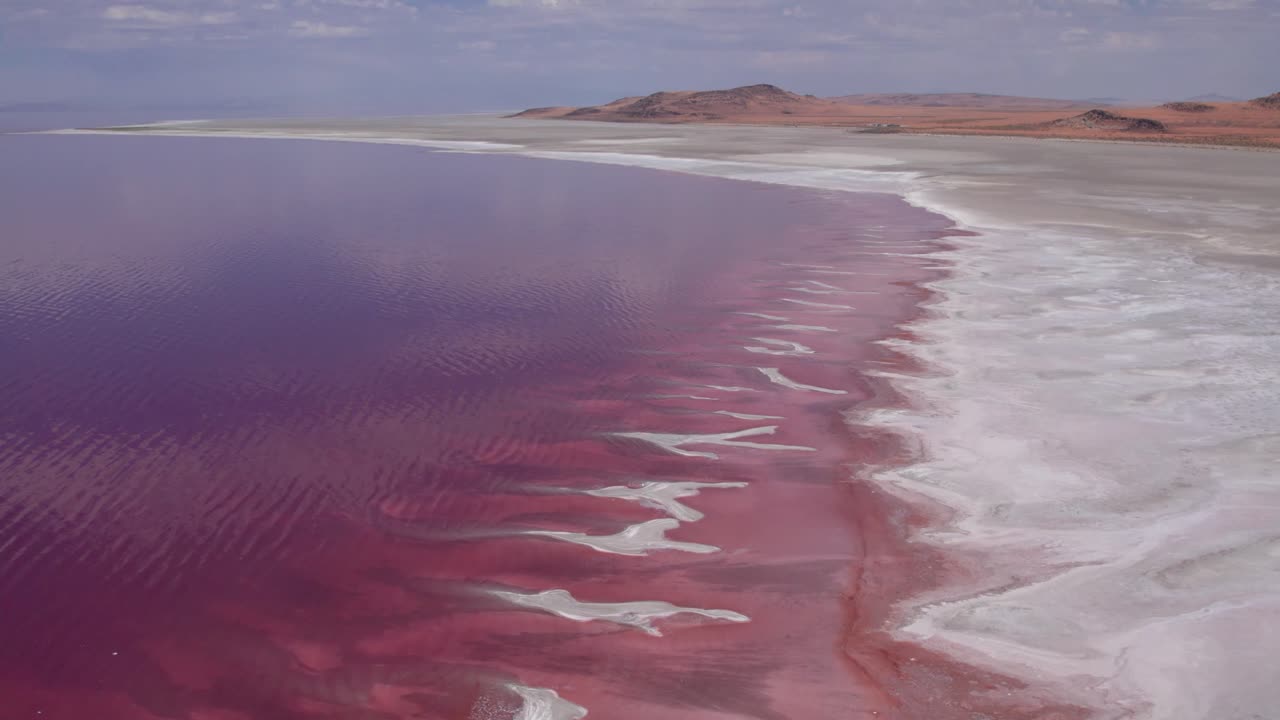 Pink Great Salt Lake, Utah shoreline and salt flats from an aerial drone perspective