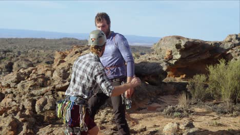 Climbers-reaching-successful-on-top-of-cliff-4k