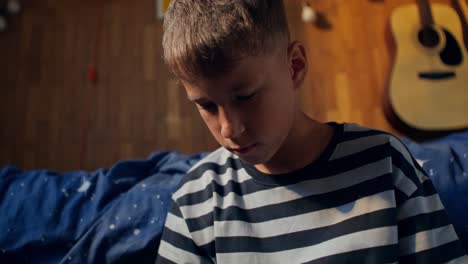 boy sitting in bedroom