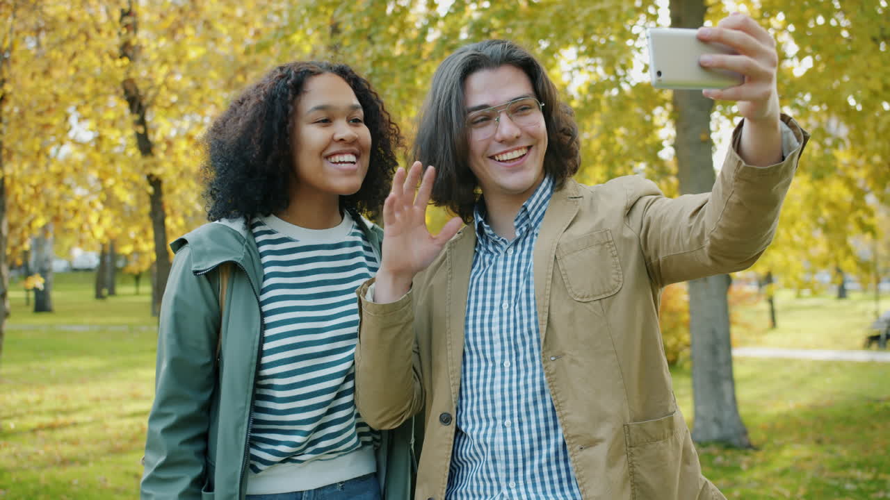 Young Couple Taking a Selfie in a Park