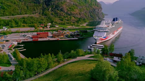 aerial drone shot of cruise ship and ferry ship arriving flam port in norway during sunny day