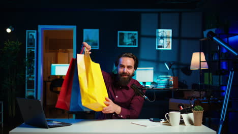 excited media star holding colorful shopping bags