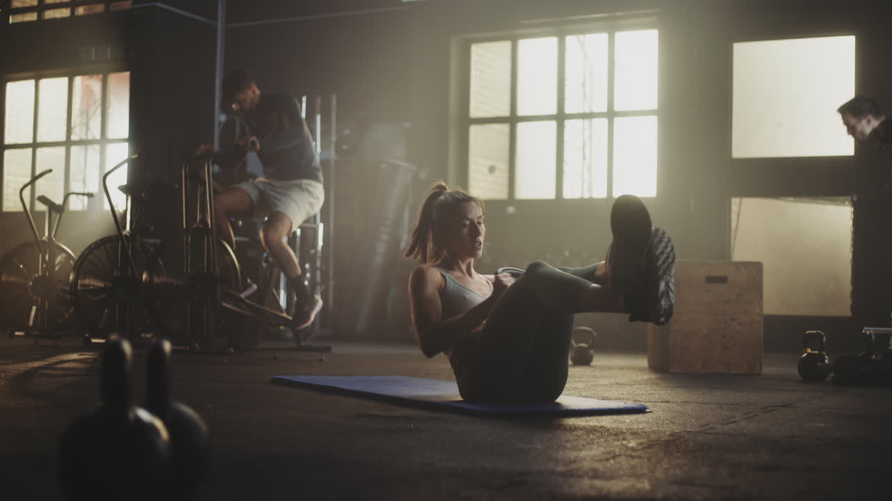 Woman and man doing exercises in a gym
