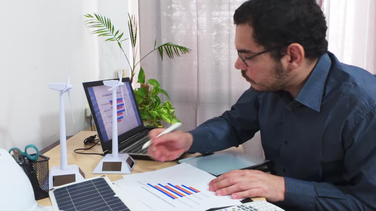 Engineer Analyzing a Bar Chart and Making Notes