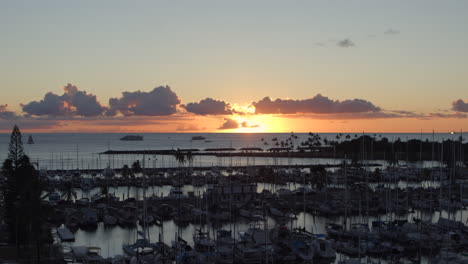 sunset over boats in ala wai boat harbor in honolulu, hawaii on oahu island