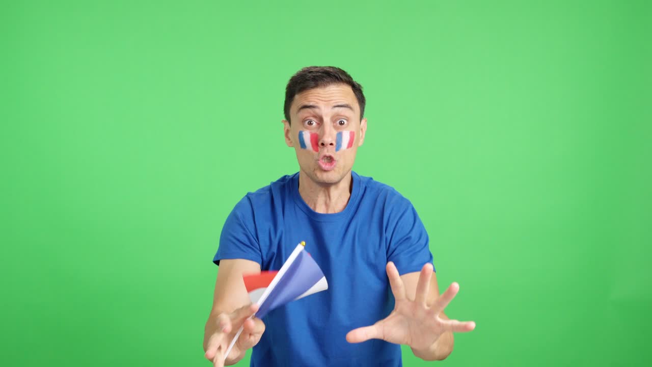 Passionate french supporter screaming and waving a national flag