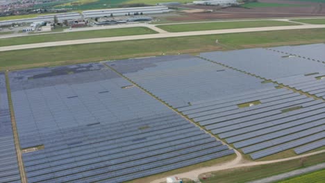 huge photovoltaic solar farm by the airport, aerial view