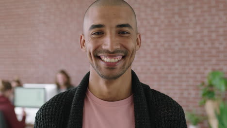 portrait-of-handsome-young-mixed-race-man-in-contemporary-office-workspace-laughing-cheerful-enjoying-start-up-business
