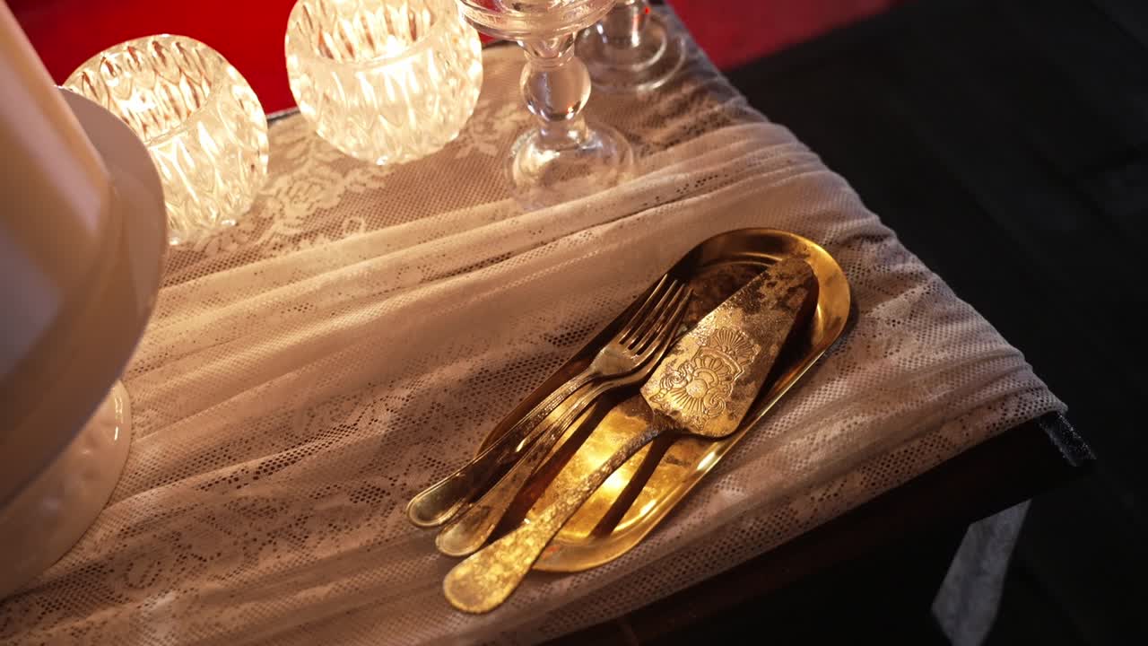 Elegant Gold Cake Knife and Fork on Lace Tablecloth